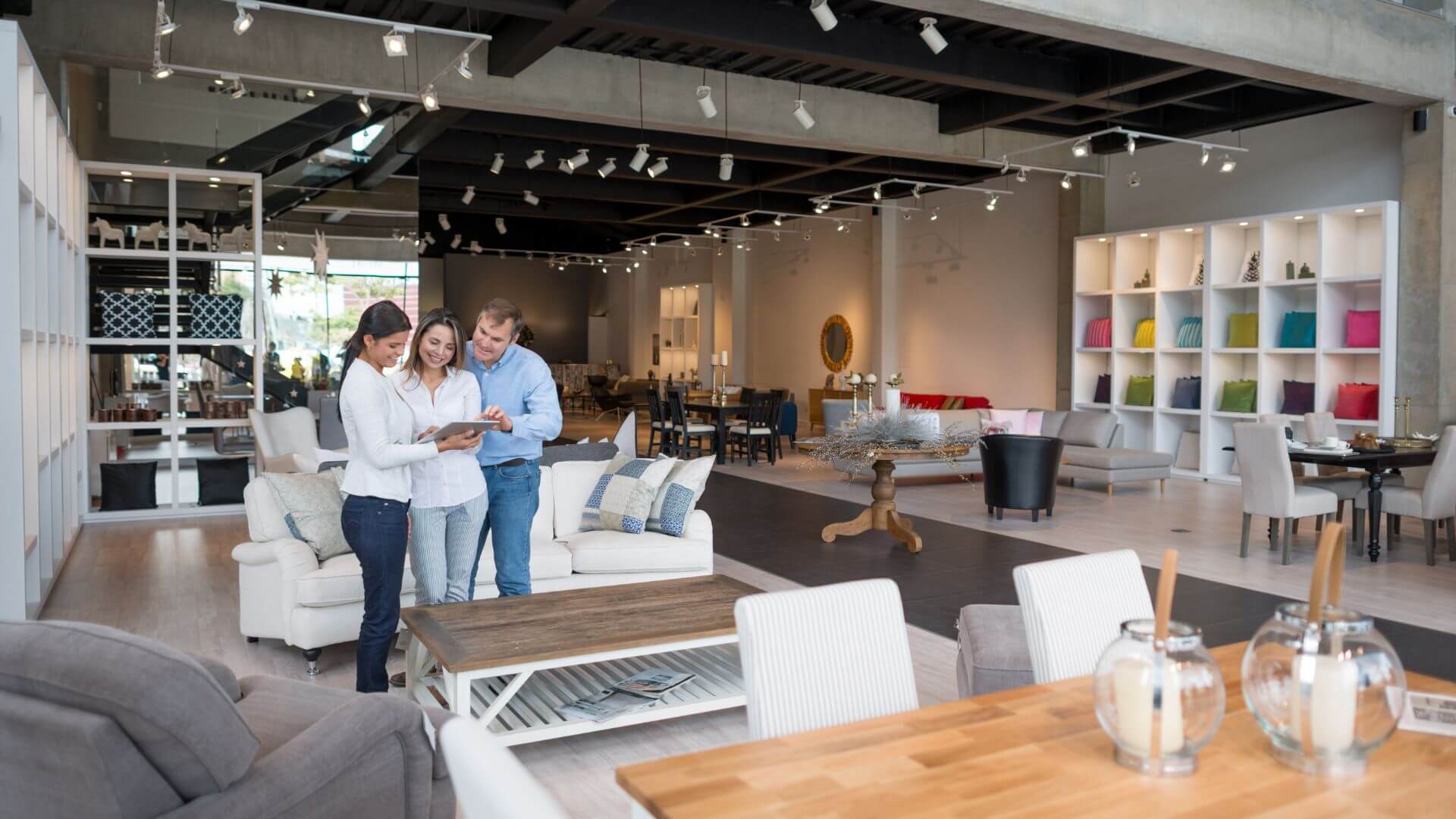 A couple using a tablet in a furniture store, using visual search