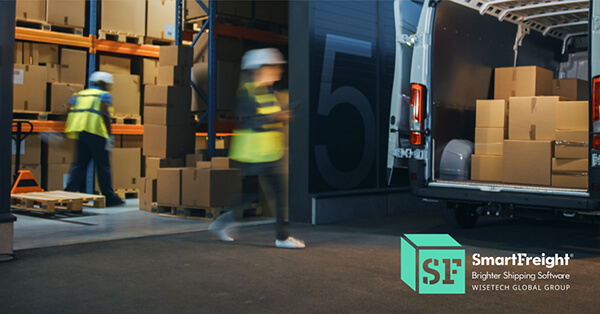 Warehouse workers moving boxes near a delivery van as part of the eCommerce shipping process